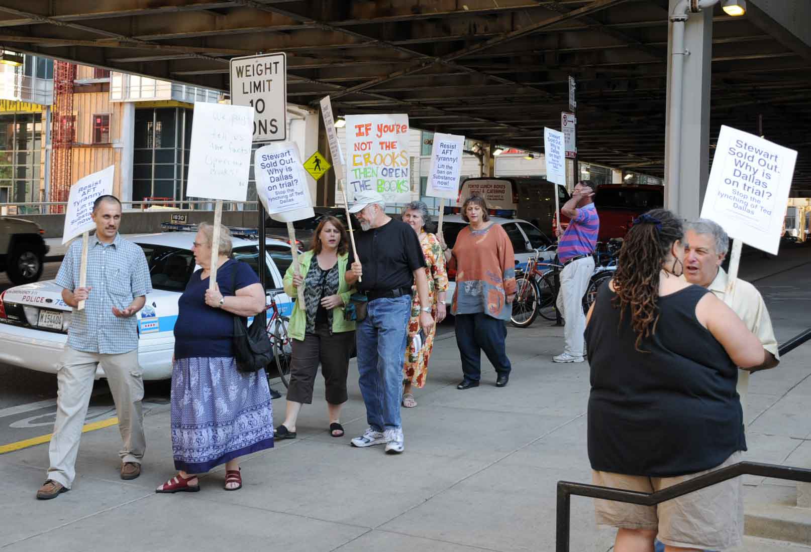 June 12, 2008. Members of all three dissident caucuses in the Chicago Teachers Union picketed outside the Merchandise Mart protesting the attempt by CTU President Marilyn Stewart to kick Vice President Ted Dallas out of the union. The pickets were forced to hold their protest on Wells St. at Kinzie, rather than in front of the Mary, when Marilyn Stewart demanded that Mart security refuse to all the protester, all of whom were union members, to march on Mart property (which includes that vast area on the Chicago River in front of the Mart. As the summer went on, more and more union members realized that Stewart’s plan was to eliminate Dallas from the union leadership while most union members were out of school and isolated from their union. Stewart re-scheduled the unprecedented hearings against Dallas throughout the summer despite warnings — including in court — that the CTU Constitution and By-Laws did not permit what she was attempting. On the days when Stewart scheduled Executive Board hearings against Dallas, union members and reporters were barred from the union’s expensive Merchandise Mart offices — despite the fact that the hearings were held during regular union business hours. Substance photo by George N. Schmidt. 